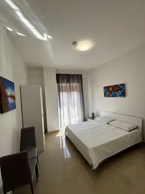 a bedroom with a white bed and a window at Terrasini downtown City Life in Terrasini