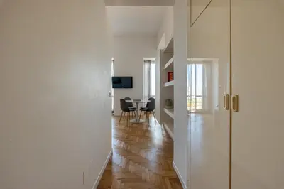 a hallway with white walls and a dining room with a table at La Casa al Foro Vista Mare by Wonderful Italy in Palermo