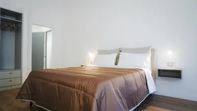 a bedroom with a large bed with white pillows at Harbour Front - Luxury Rooms in Palermo