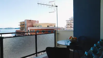 a view of a balcony with a table and chairs at Harbour Front - Luxury Rooms in Palermo