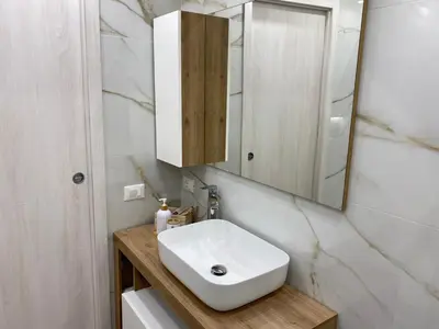 a bathroom with a white sink and a mirror at Primo Piano in Palermo