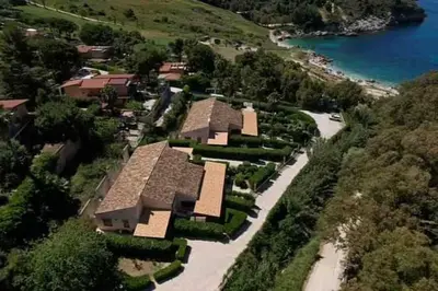 arial view of a house on a hill near the water at Villa Rossa by Sicily Travelling Villas in Scopello