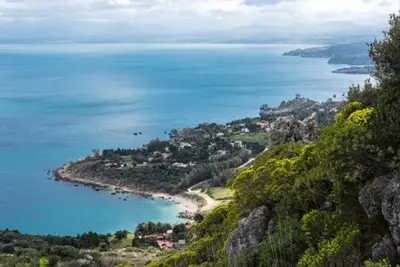 a view of a beach and the ocean from a mountain at Villa Bianca by Sicily Travelling Villas in Castellammare del Golfo