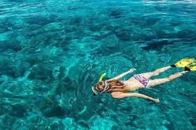 a woman laying in the water with a frisbee at Villa Bianca by Sicily Travelling Villas in Castellammare del Golfo