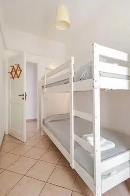 a white bunk bed in a room with a hallway at Villa Bianca by Sicily Travelling Villas in Castellammare del Golfo