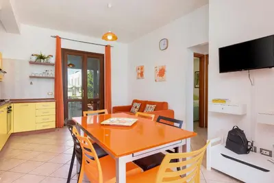 a living room with a couch and a table at Trilocale Piano Terra Con Veranda in San Vito lo Capo