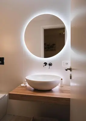a bathroom with a white sink and a mirror at Papireto Rooms in Palermo
