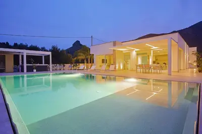 a large swimming pool in front of a house at Villa the Twins in Castellammare del Golfo