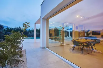 a dining area of a house with a table and chairs at Villa the Twins in Castellammare del Golfo