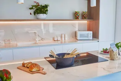 a kitchen with a counter top with a bowl of bread at Villa the Twins in Castellammare del Golfo