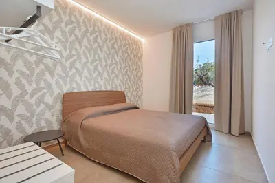 a bedroom with a bed in a room with a window at Villa the Twins in Castellammare del Golfo