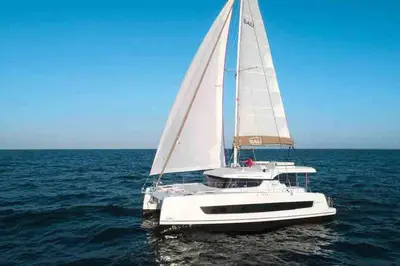 a white sailboat in the ocean on the water at Sicily by Catamaran in Palermo