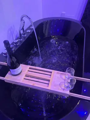 a bath tub with a bottle of wine and glasses at Sweet dreams in Palermo