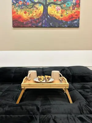a tray of food on top of a couch with a painting at Sweet dreams in Palermo