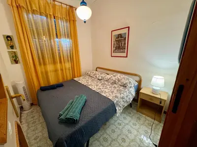 a small bedroom with a bed and a table at Villa Pino in Carini