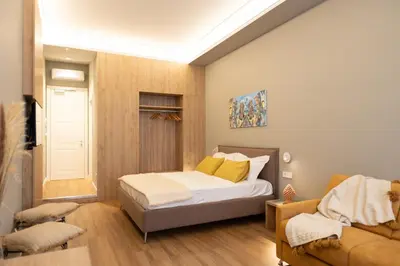 a bedroom with a bed and a couch at Quattro Canti Deluxe in Palermo