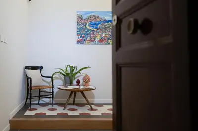 a table and chair next to a door with a small table and a table at Quattro Canti Deluxe in Palermo