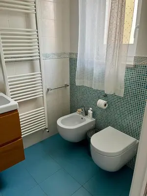 a small bathroom with a toilet and a sink at Casa Vacanze Sfera 6 in Palermo