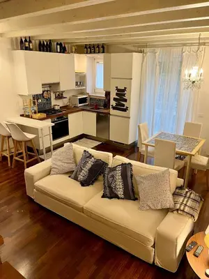 a living room with a couch and a kitchen at Casa Vacanze Sfera 6 in Palermo