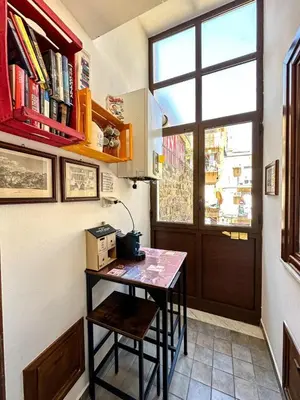a small table in a room with a window at Balat City in Palermo