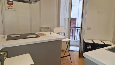 a kitchen with a counter and a table and chairs at Brunetto House in Palermo