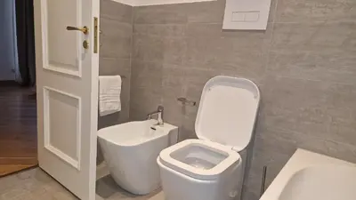 a bathroom with a toilet and a sink at Brunetto House in Palermo