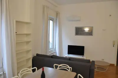 a living room with a couch and a television at Brunetto House in Palermo