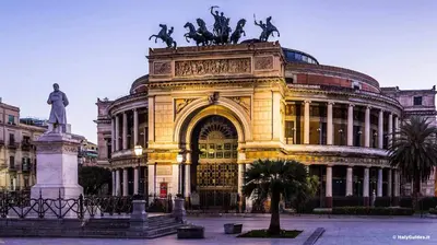 a building with a statue in front of it at Brunetto House in Palermo