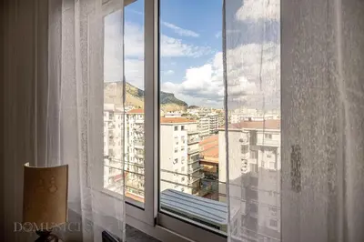 a window with a view of a city at Chez Gabriel by DomuSicily in Palermo