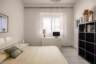 a white bedroom with a bed and a window at Chez Gabriel by DomuSicily in Palermo