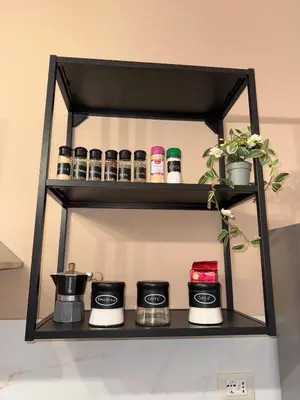 a shelf with coffee makers and plants on it at Suli D'amuri in Palermo