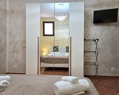 a bedroom with a large mirror and a bed at Maison Cattedrale - Proppro SRL - Palermo in Palermo