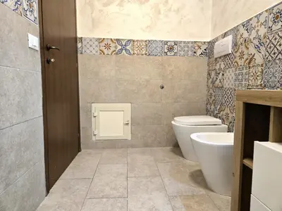 a bathroom with a toilet and a sink at Maison Cattedrale - Proppro SRL - Palermo in Palermo