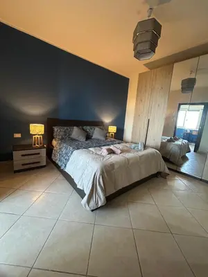 a bedroom with a large bed and two lamps at Casa Aura in Palermo