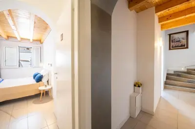 a small room with a bed and a staircase at Opera Suite in Castellammare del Golfo