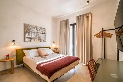 a bedroom with a bed and a table in a room at Villa Brezza in Partinico