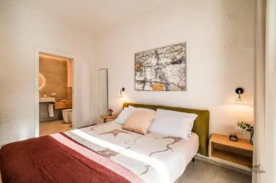 a bedroom with a bed with a red and white blanket at Villa Brezza in Partinico