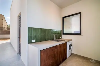 a bathroom with a sink and a washing machine at Villa Brezza in Partinico
