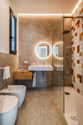 a bathroom with a tub and a sink and mirror at Villa Armonia in Partinico