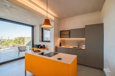 a kitchen with an orange island in the middle at Villa Armonia in Partinico