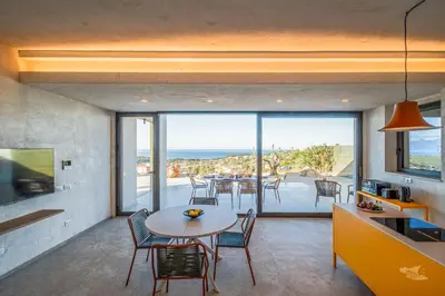 a kitchen and dining room with a table and chairs at Villa Armonia in Partinico
