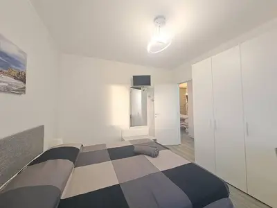 a bedroom with a black and white striped bed at Villa Elios Adriana con piscina a Lascari in Lascari