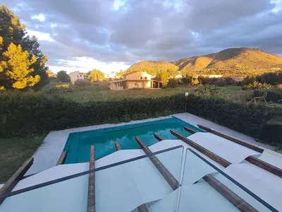 a swimming pool in front of a house at Villa Elios Adriana con piscina a Lascari in Lascari