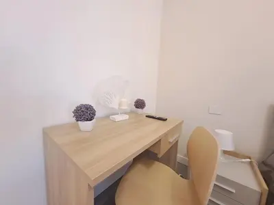a wooden desk with a chair and flowers on it at Villa Elios Adriana con piscina a Lascari in Lascari