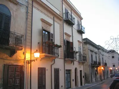a group of buildings with balconies and a street at Dimore Barraco - SiciliaDaMare in Castellammare del Golfo