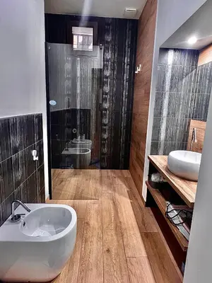 a bathroom with a toilet and a sink and a shower at Trinacria Guest house in Palermo