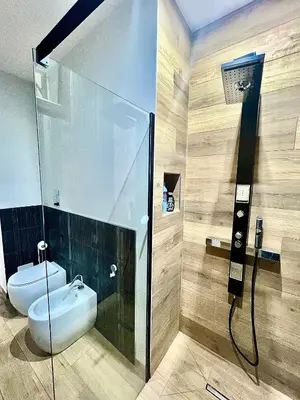 a bathroom with a shower with a sink and a toilet at Trinacria Guest house in Palermo