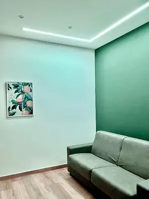 a living room with a couch and a blue wall at Trinacria Guest house in Palermo