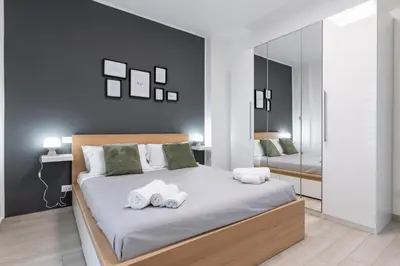 a bedroom with a bed with two towels on it at GuestHost - Sicilian Dream - Modern Central Apartment in Palermo