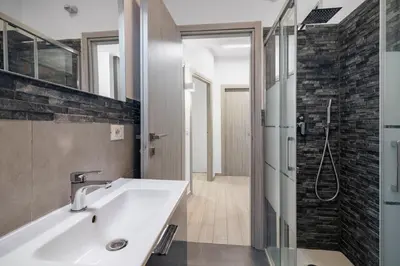 a bathroom with a sink and a shower at GuestHost - Sicilian Dream - Modern Central Apartment in Palermo